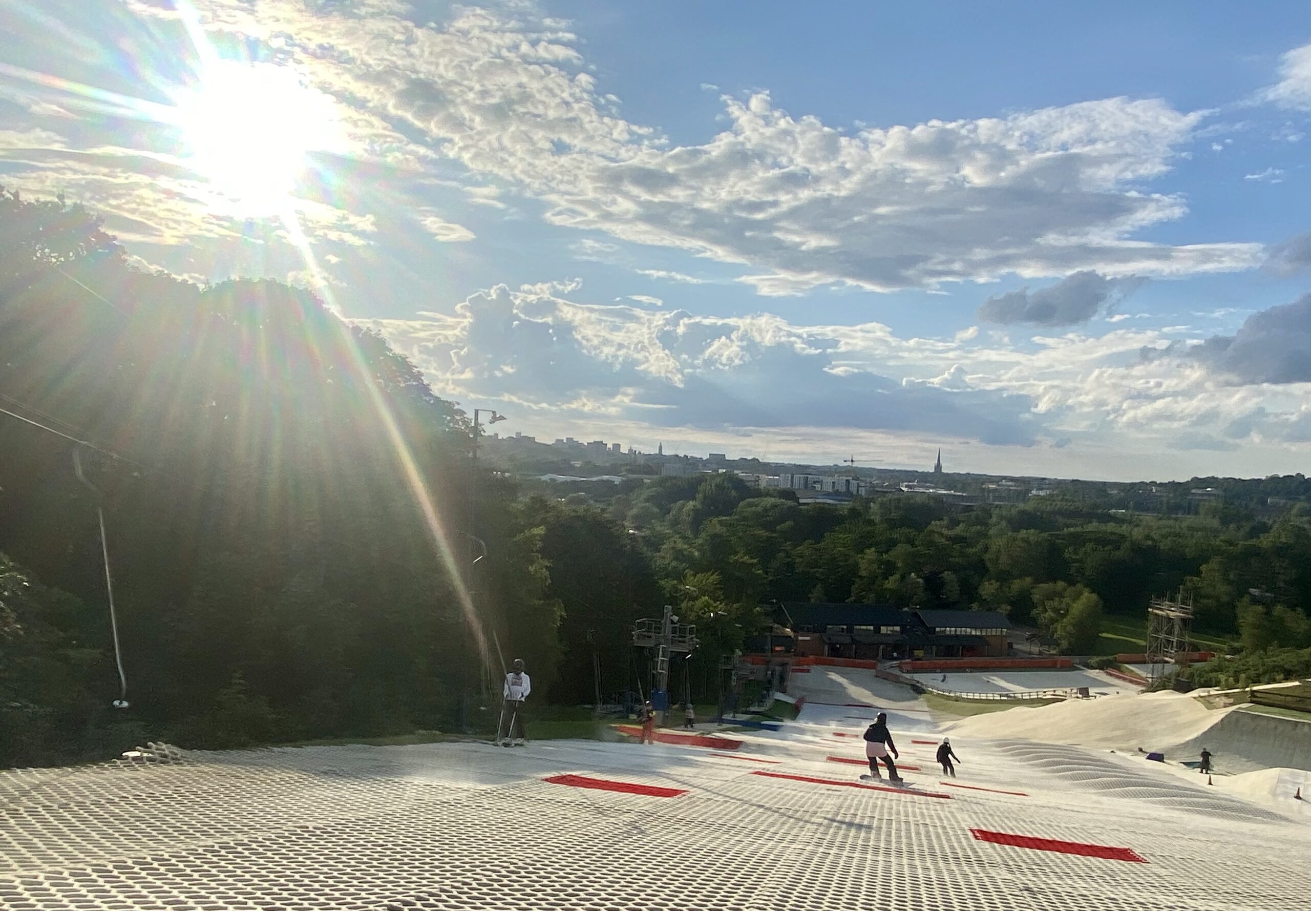 sun shines on main slope as riders go down